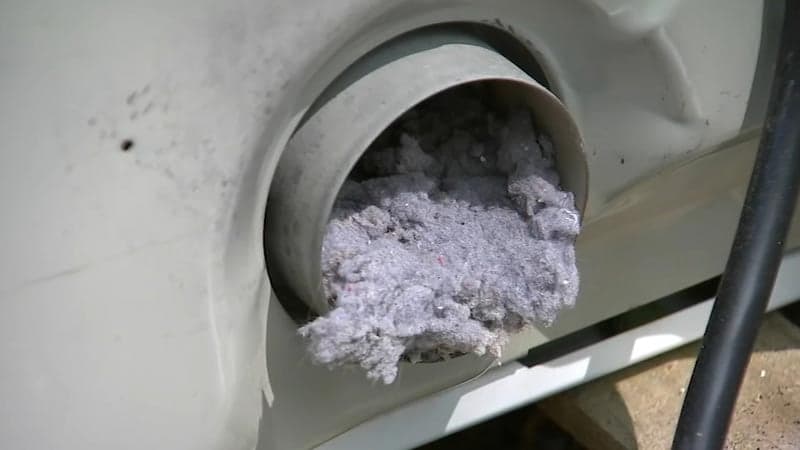 A dryer vent exterior cap packed with built-up lint — the fire risk dryer vent cleaning removes